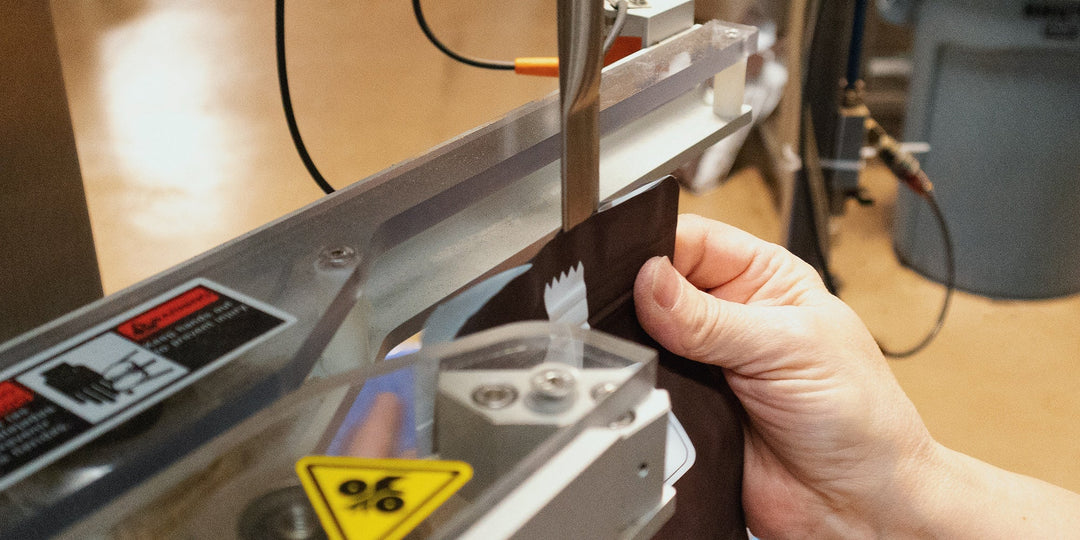 A bag of coffee being nitrogen flushed and band sealed to preserve freshness.