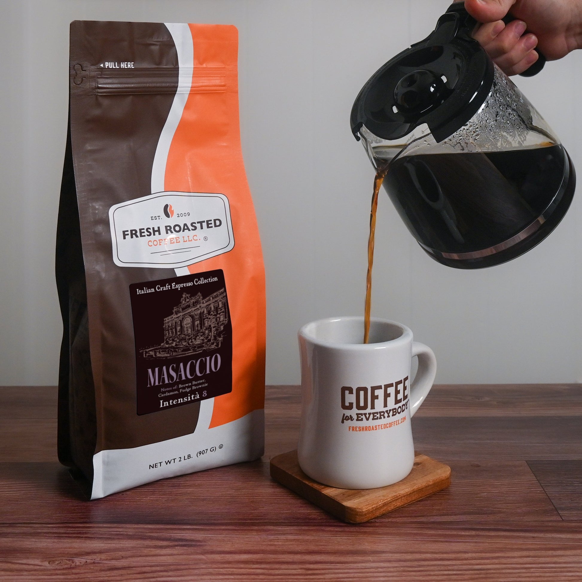 Fresh Roasted Coffee Masaccio espresso freshly brewed and poured into a mug, capturing its warm brown butter aroma and smooth Intensity 8 flavor.