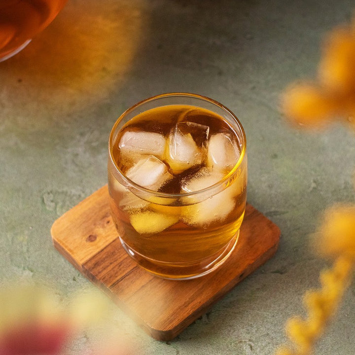 Positively Botanicals Organic Cascara herbal supplement steeped and served over ice, creating a light, naturally caffeinated drink.