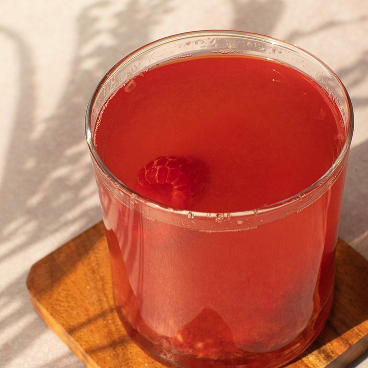 Positively Botanicals Organic Raspberry Leaf herbal supplement infused in water, creating a nutrient-rich, naturally flavored drink.
